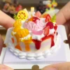 DIY Fake Dessert Cake Craft Kit Finished Example Finished example of a DIY fake dessert cake craft kit with fruit-style toppings, pink scoop centerpiece, and colorful sauce-like drips