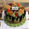 Finished example of a DIY fake dessert cake craft kit with chocolate-drip styling, green decorative details, berry toppings, and layered handmade accents