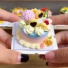 Sample finished piece from a DIY Miniature Citrus Star Cake Kit featuring green drip icing, fruit-inspired decorations, flowers, and a star-shaped cake design.