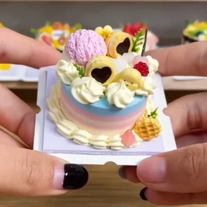 Sample finished piece from a DIY Miniature Citrus Star Cake Kit featuring green drip icing, fruit-inspired decorations, flowers, and a star-shaped cake design.