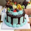DIY Fake Dessert Cake Craft Kit with Blue Decoration Finished example of a DIY fake dessert cake craft kit with chocolate-drip styling, pale blue cream-like decoration, berry toppings, and fruit-inspired accents