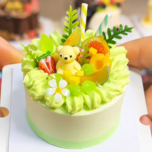 DIY Miniature Green Teddy Bear Clay Cake Kit Finished example of a DIY miniature clay cake kit with green cream-style details, teddy bear, fruit decorations, leaves, and flower accents