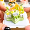 Sample finished piece from a DIY Miniature Citrus Star Cake Kit featuring green drip icing, fruit-inspired decorations, flowers, and a star-shaped cake design.