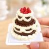 DIY Miniature Strawberry Chocolate Cake Kit Finished Example Finished example of a DIY miniature strawberry chocolate cake kit with two tiers, cream-like piping, red strawberries, and pearl accents