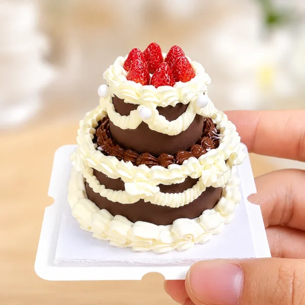 DIY Miniature Strawberry Chocolate Cake Kit Finished Example Finished example of a DIY miniature strawberry chocolate cake kit with two tiers, cream-like piping, red strawberries, and pearl accents